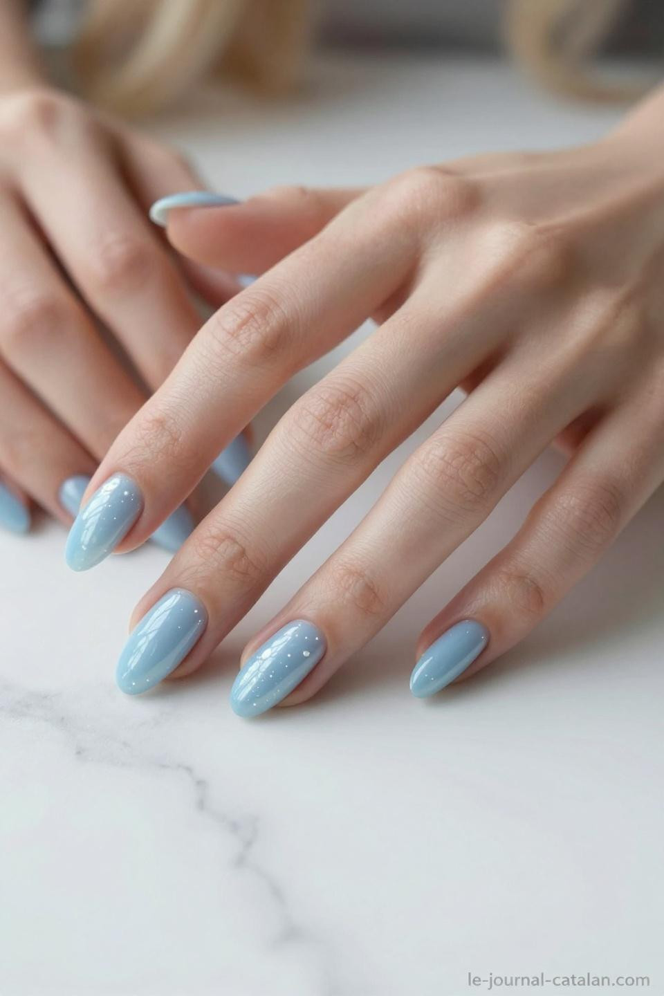 Blue and white nails with baby blue base and pearl shimmer iridescent finish