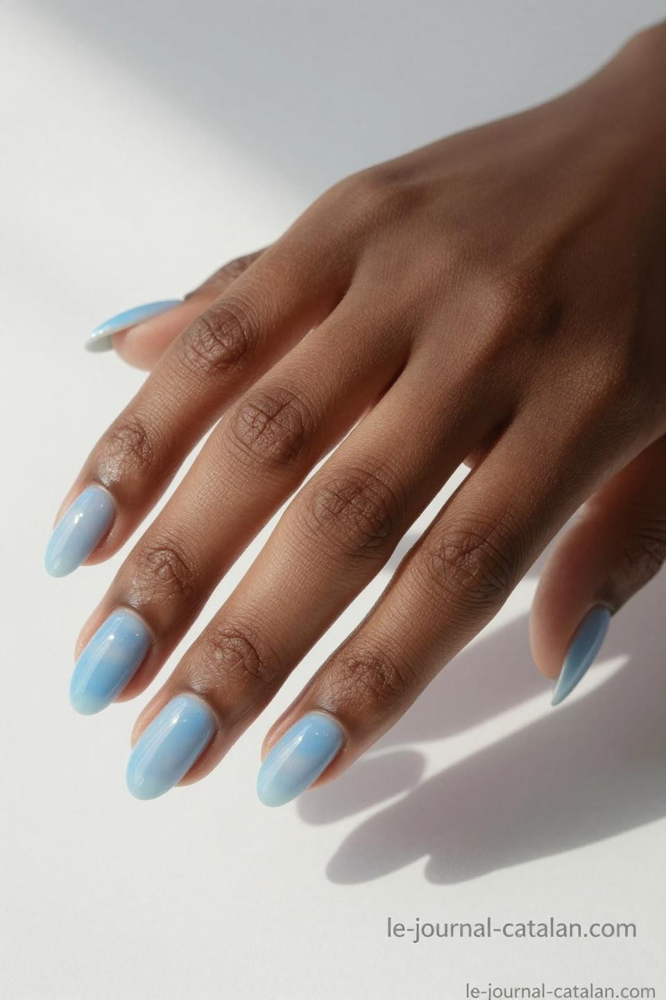 Blue nails inspiration featuring baby blue gel in almond shape with glossy finish