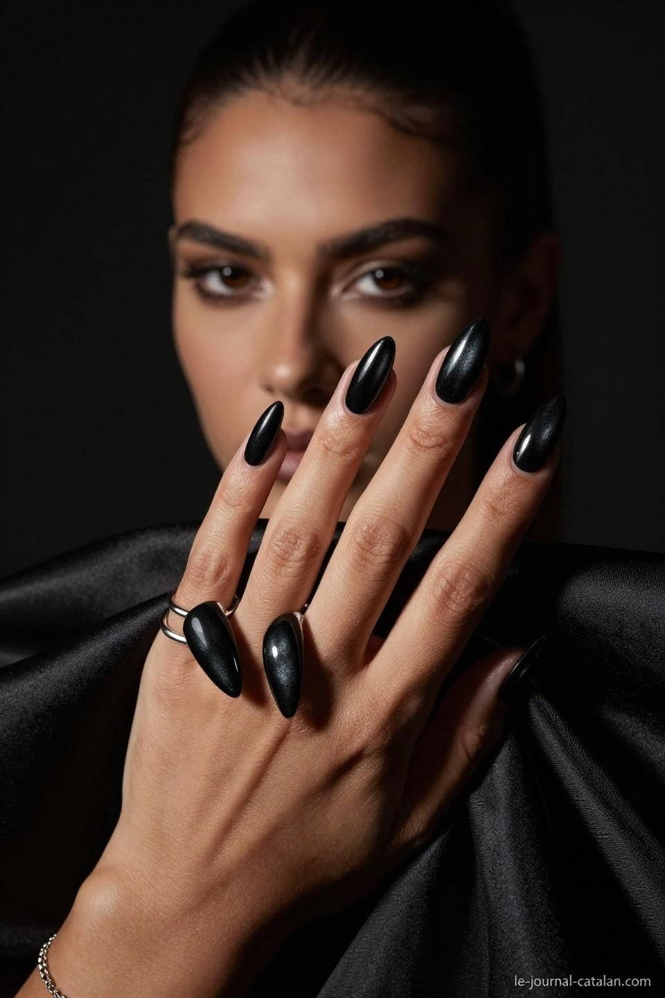 witchy nails in glossy jet black with dramatic shadow play and gold chain accents