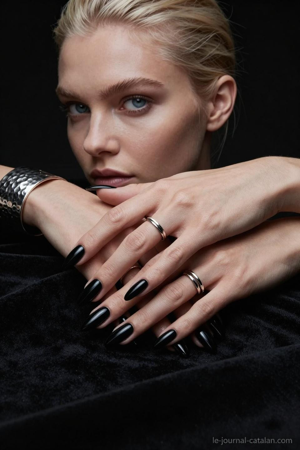 black almond nails in glossy gel with sculptural lighting and platinum blonde styling