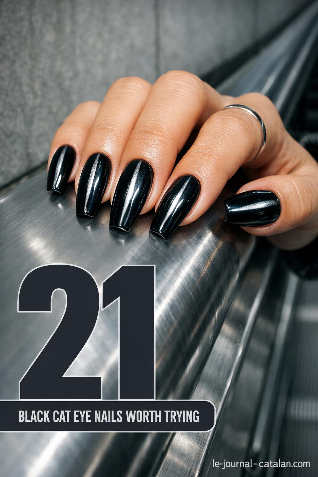 Black cateye nail design featuring dark feminine styling with glossy finish and curved eye-catching pattern on manicured nails