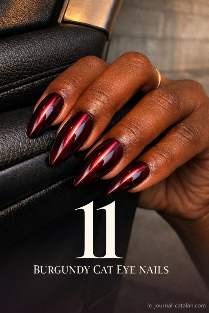 Red cat eye nail art featuring burgundy polish with striking linear pattern and dark cherry finish for feminine nail designs