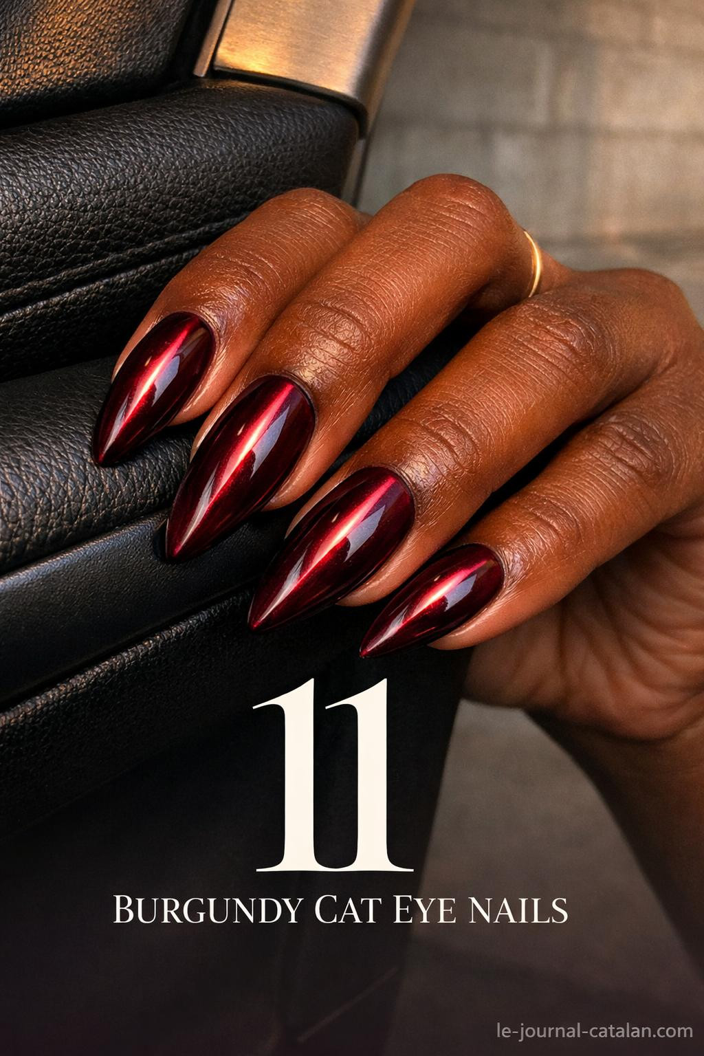 Red cat eye nail art featuring burgundy polish with striking linear pattern and dark cherry finish for feminine nail designs
