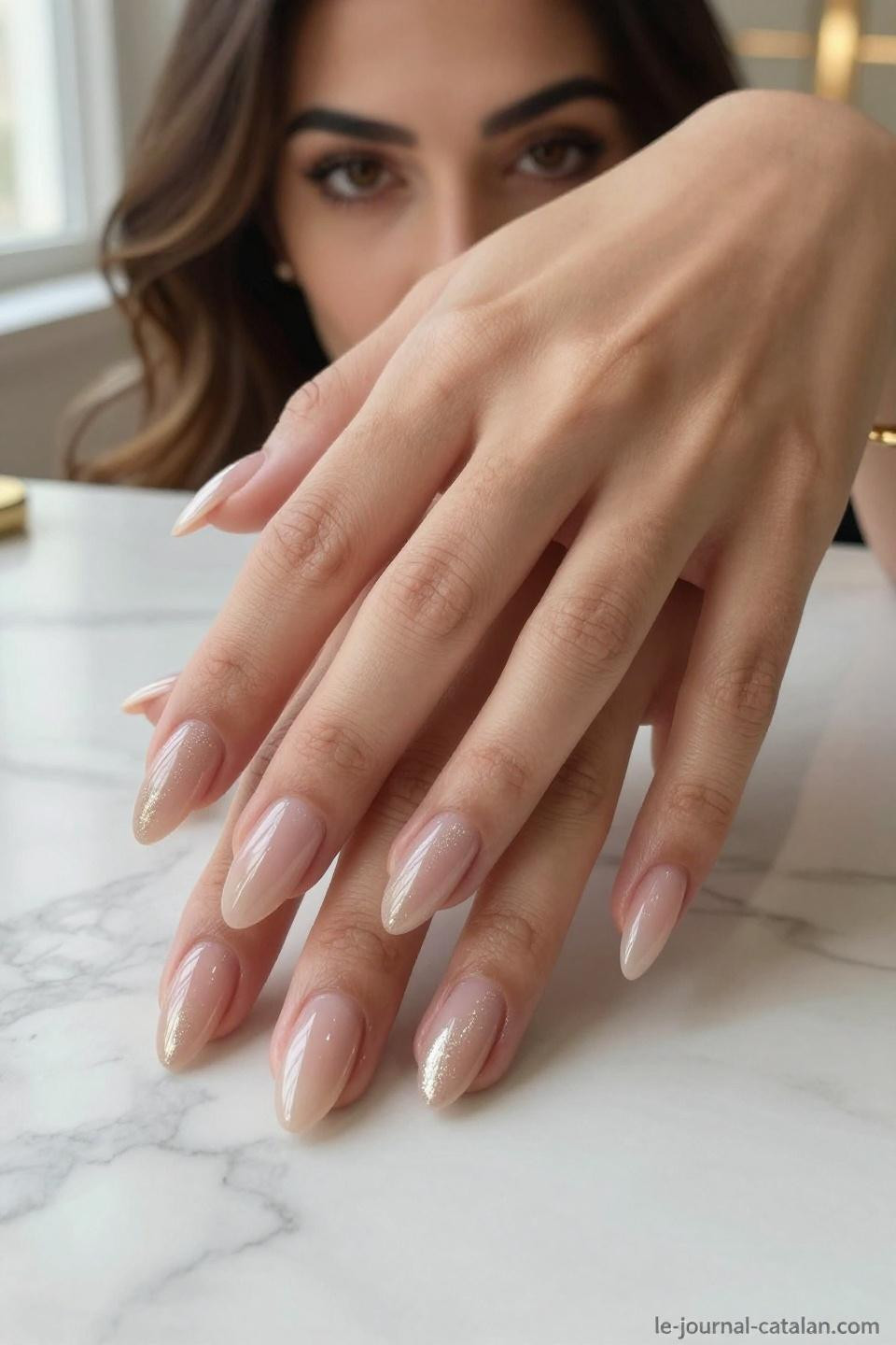 Pretty Almond Nails Classy nude with rose gold shimmer gradient on warm olive hands