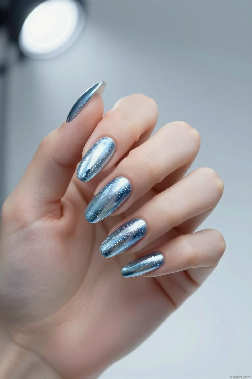 baby blue chrome nails with mirror finish on almond shape