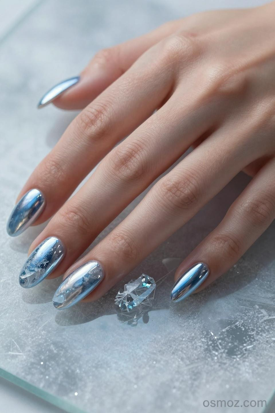 light blue chrome nails with artistic design details