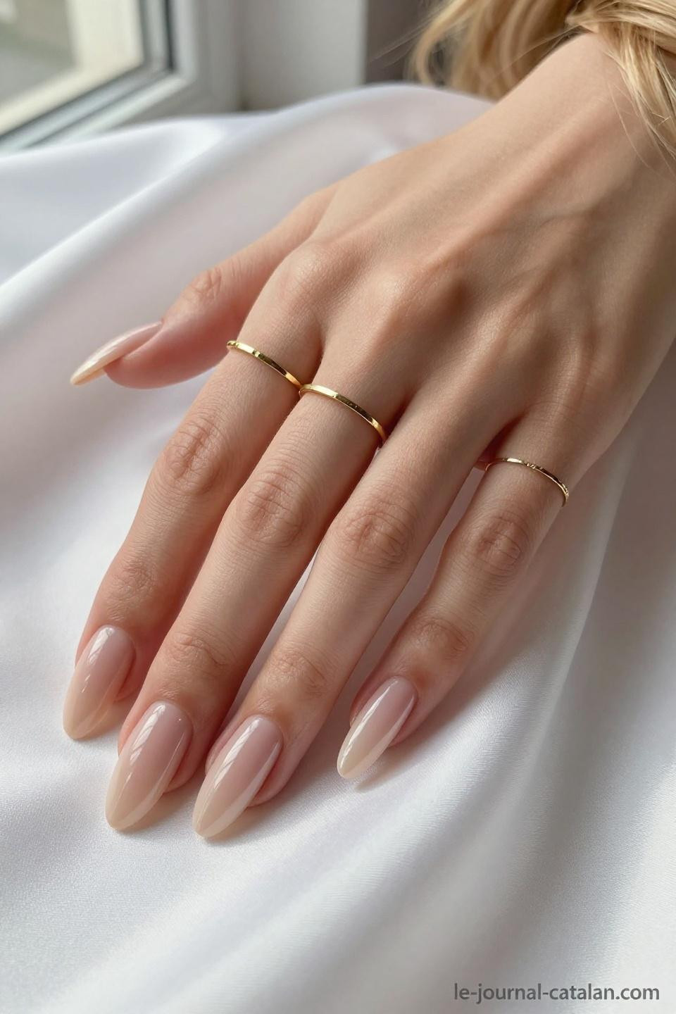 Almond Acrylic Nails Designs featuring nude champagne with dimensional glossy finish