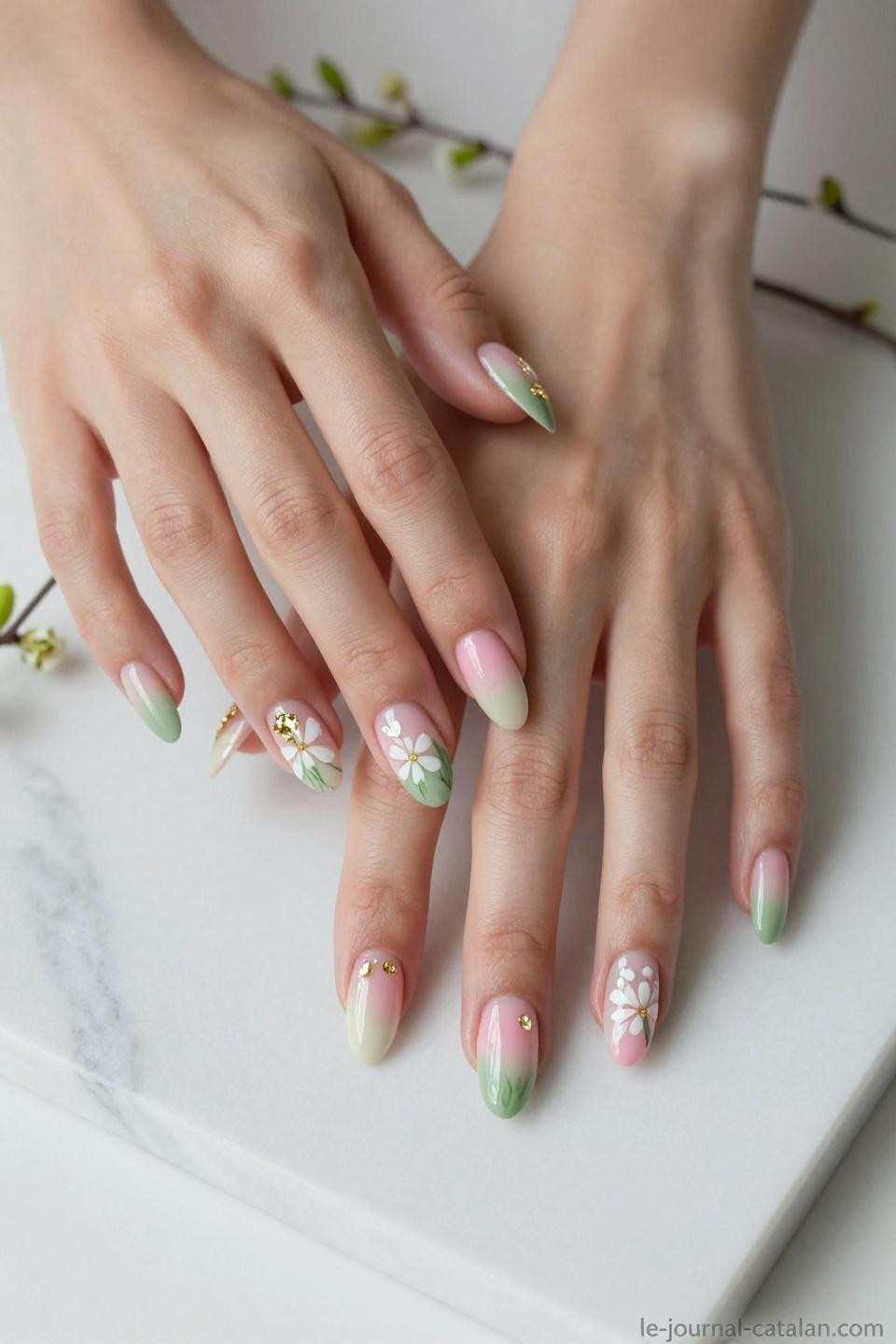 March nail inspo with soft sage green gradient and cream white wildflowers