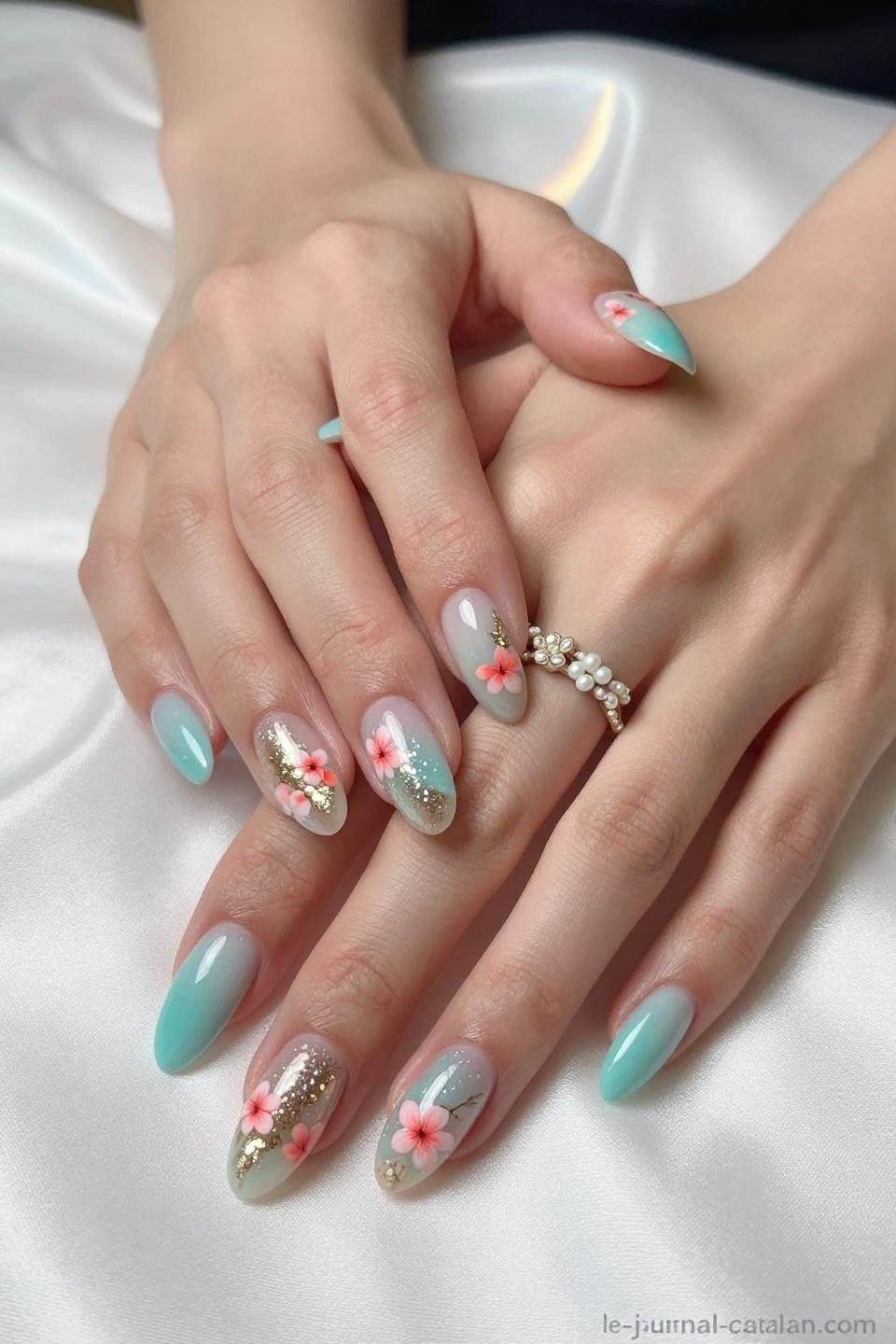March Birthday Nails Ideas showing deep aquamarine with coral pink cherry blossoms