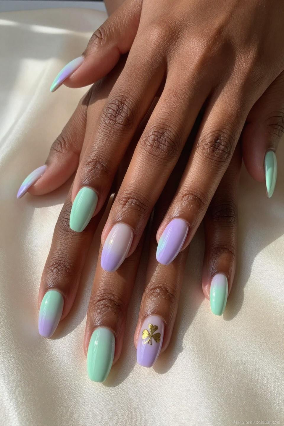 March gel nails with mint green to pale lavender gradient and gold shamrock accent
