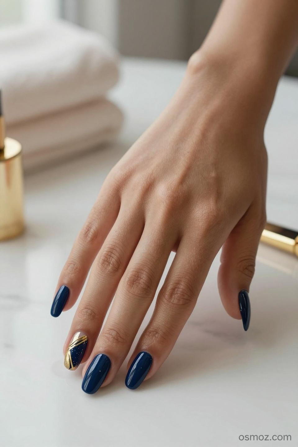 Blue Nails Ideas with navy gel polish and gold geometric accents on almond nails