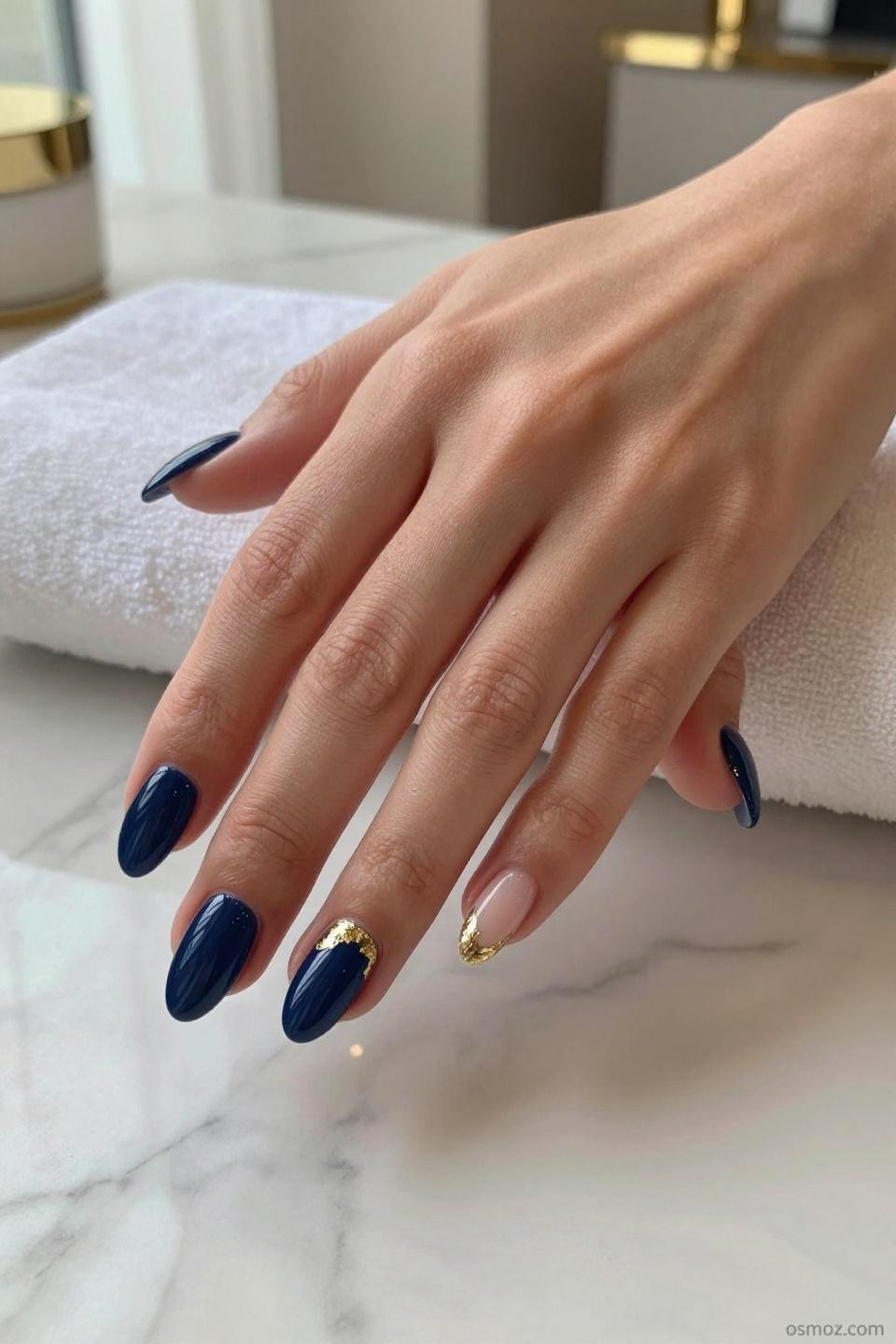 Blue Nails Ideas featuring midnight navy with gold foil fragments on almond nails