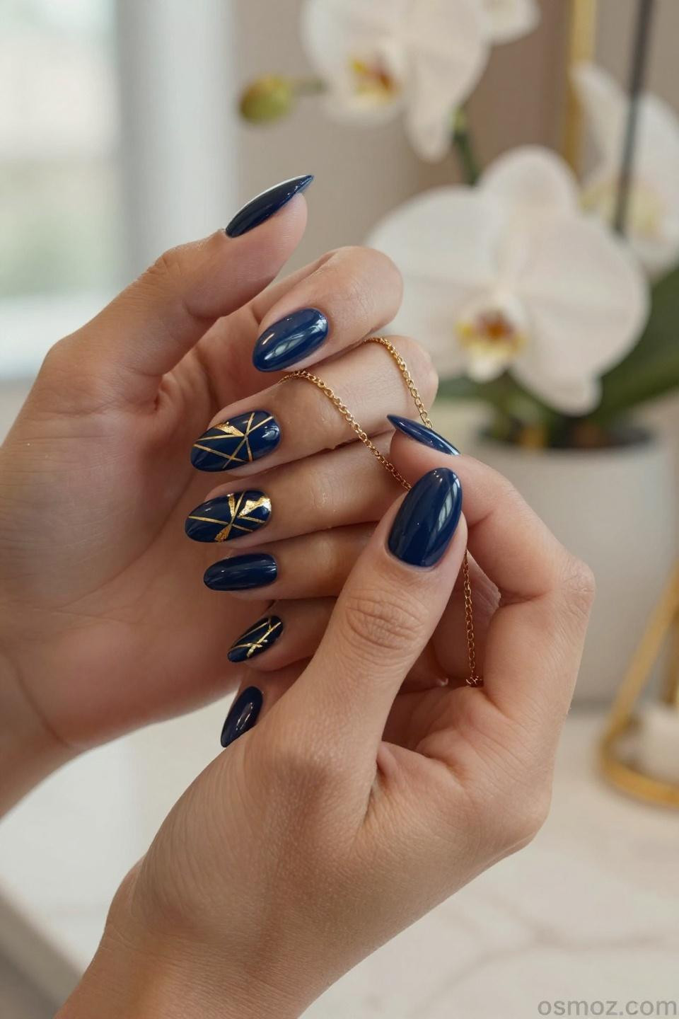 Blue Nails Ideas featuring navy gel with geometric gold patterns and negative space