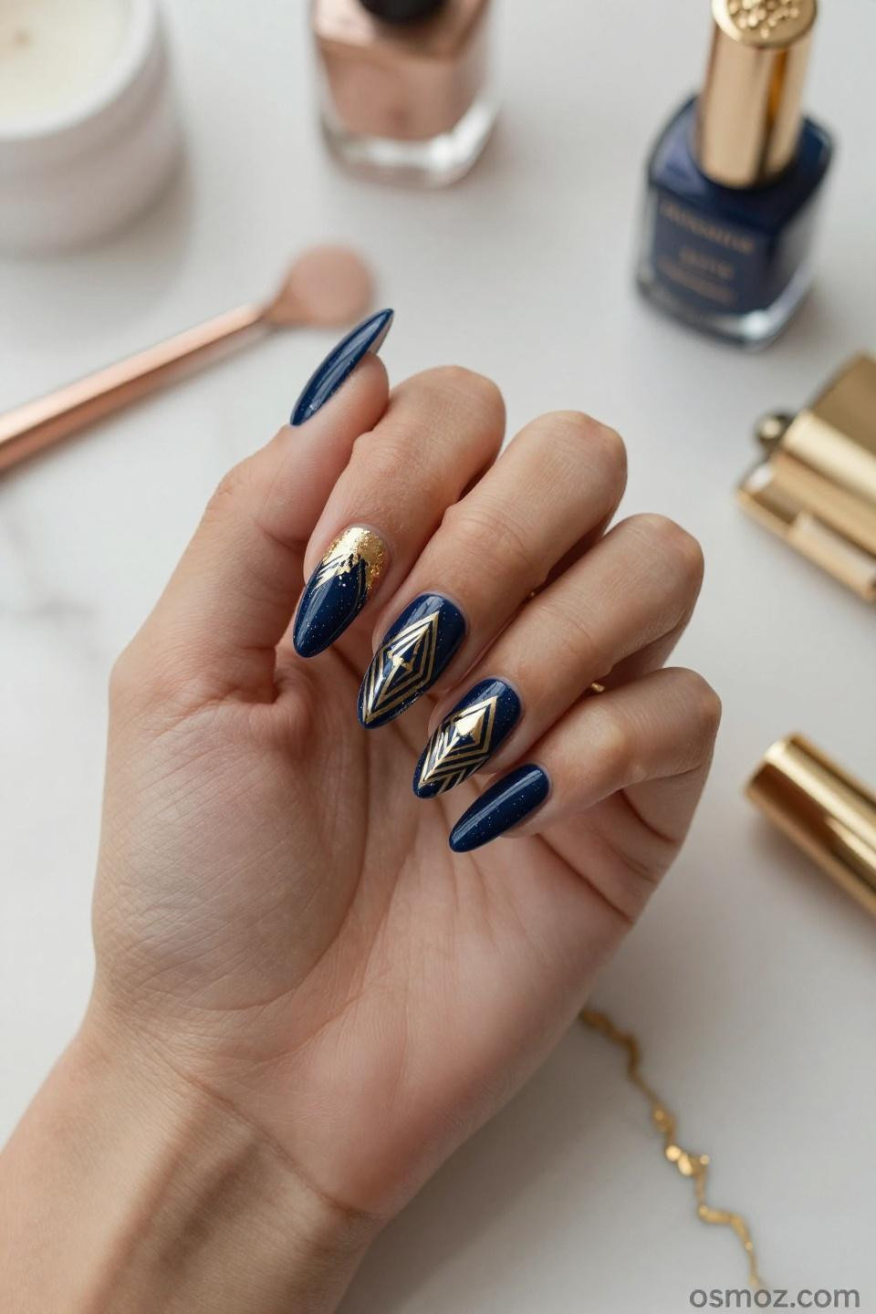 Blue Nails Ideas featuring midnight navy gel with gold leaf details on almond shape