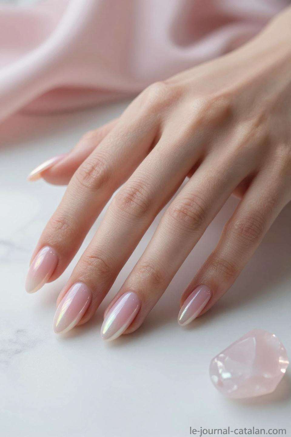 Pink chrome almond nails with iridescent shimmer and prismatic reflections