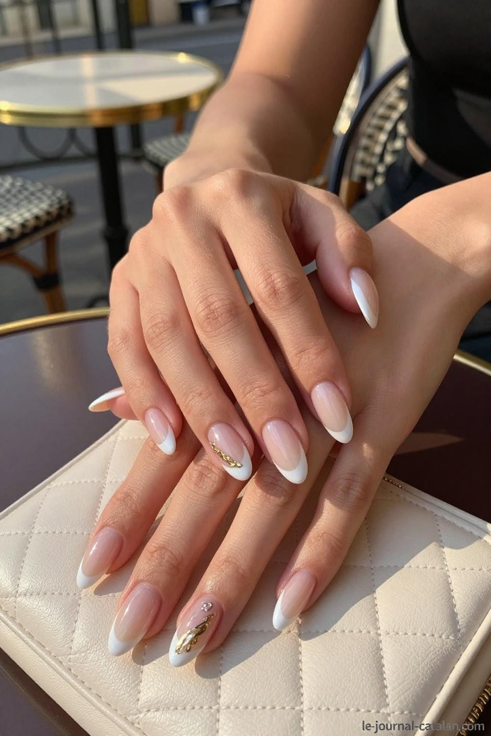 Pretty Almond Nails featuring sophisticated French tips on elegant hands