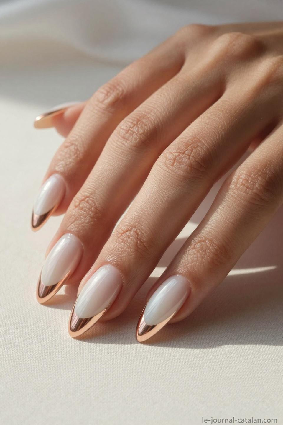 Trending Almond Nails featuring opalescent pearl base with rose gold chrome tips