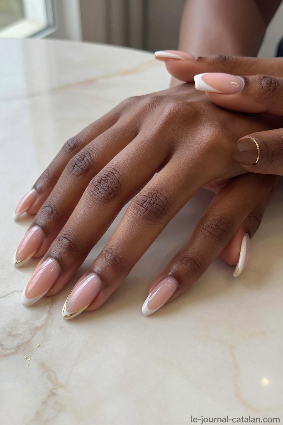Almond Nails With Design featuring warm peach French tips with gold accents