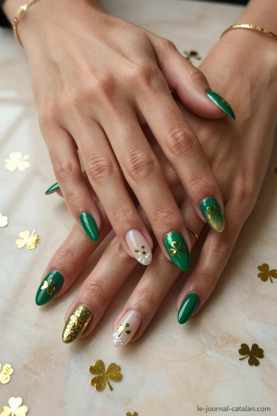 Cute St Patricks Day Nails with hand-painted gold shamrocks and gradient micro gold glitter